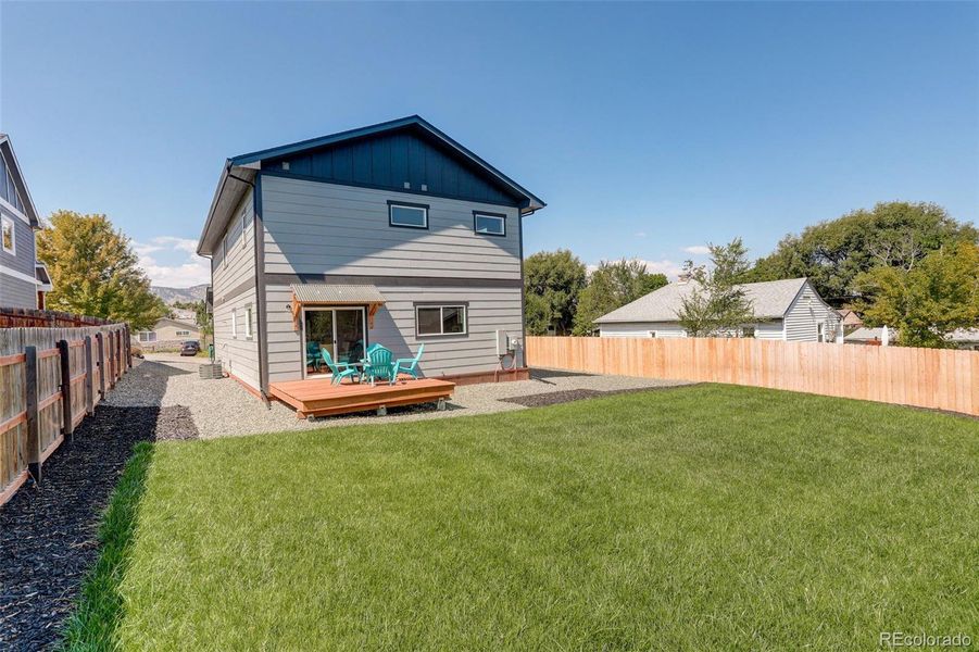 Landscaped yard , sprinkler system deck space.