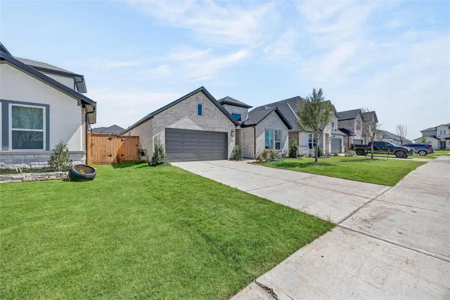 Front exterior of a new home in Trillium, Richmond, TX, highlighting curb appeal (Image 2).