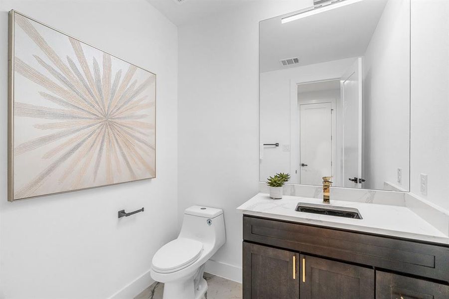 Bathroom with tile flooring, large vanity, and toilet