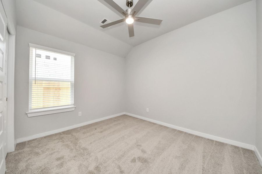Secondary bedroom features plush carpeting, large windows that let in plenty of natural light, bright paint, and spacious closets. Sample photo of completed home with similar floor plan. Actual colors and selections may vary. Secondary bedroom features plush carpeting, large windows that let in plenty of natural light, bright paint, and spacious closets. Sample photo of completed home with similar floor plan. Actual colors and selections may vary.