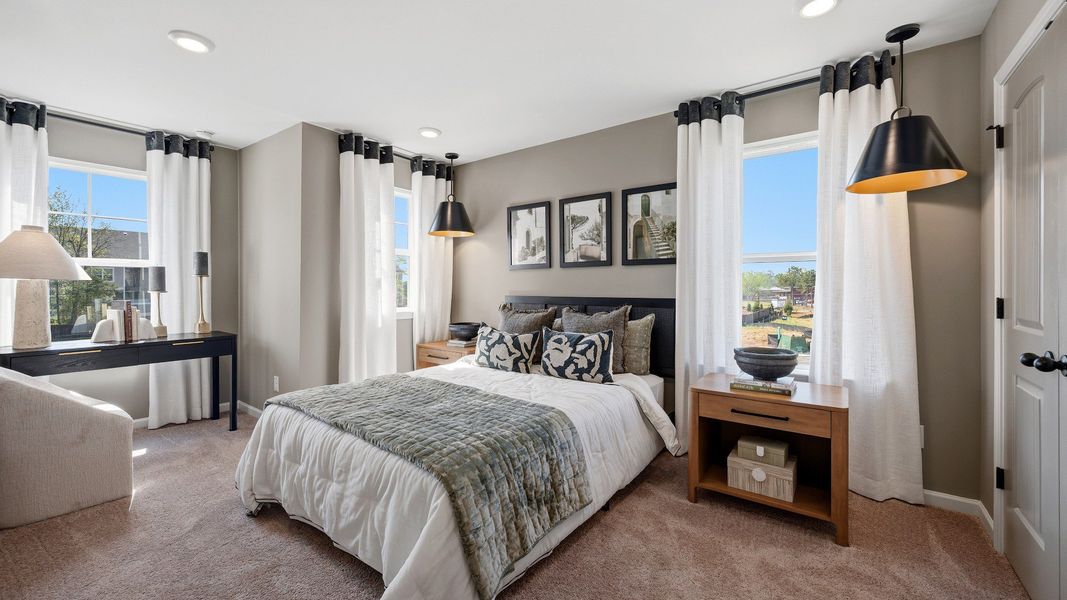 Secondary bedroom with space for desk, large window, and natural light in Langley Overlook townhome in Loganville, GA.