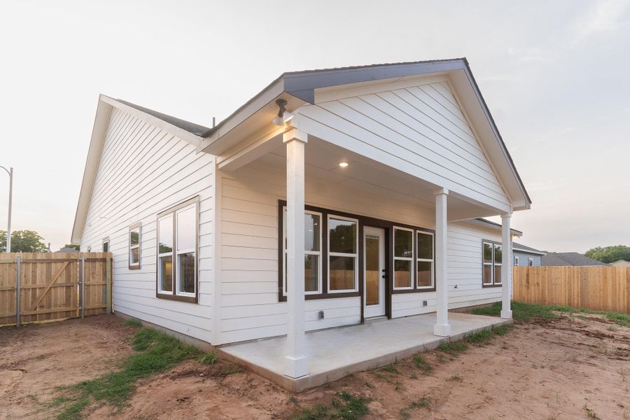 Back of property featuring a fenced backyard and a patio area
