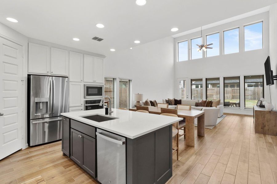 Bright kitchen workspace showing the undermount sink, dishwasher, and ample counter space for meal prep. Bright kitchen workspace showing the undermount sink, dishwasher, and ample counter space for meal prep.