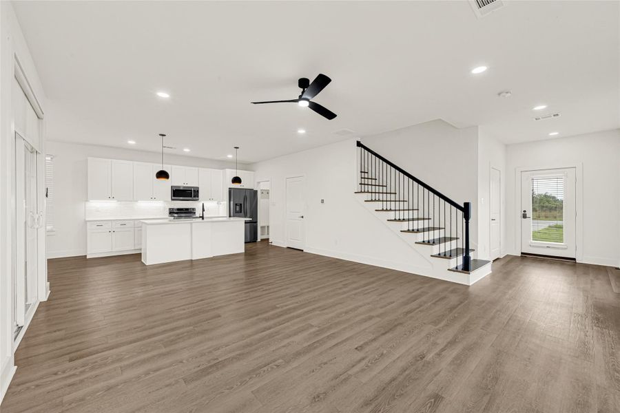 An absolute showstopper! This wide-angled shot reveals the expansive open-concept great room, making the home ideal for both entertaining and everyday living.