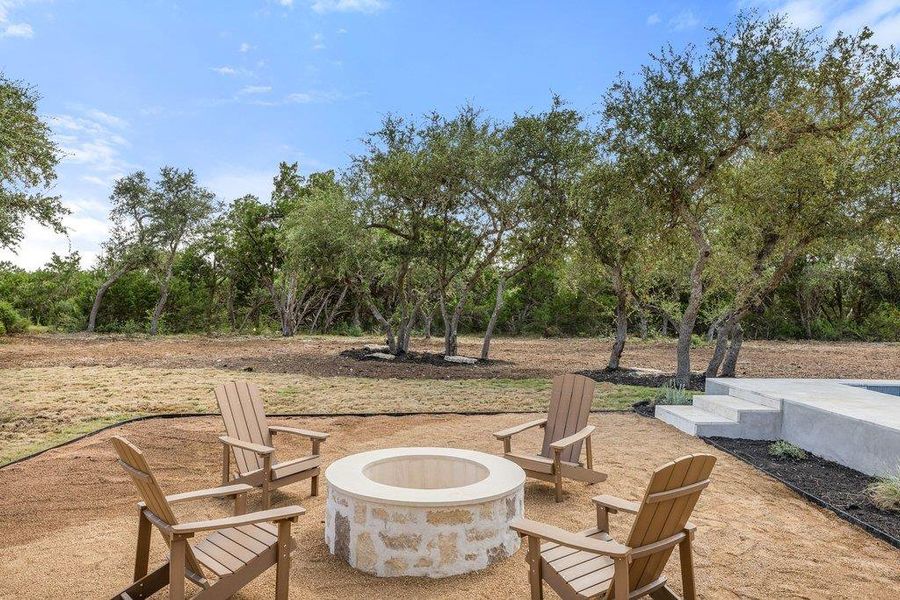 Gather around the fire pit in this generously sized backyard with a private pool.