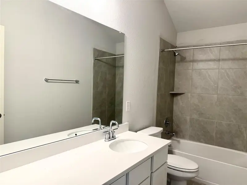 Full bathroom featuring vanity and shower / bath combination Full bathroom featuring vanity and shower / bath combination