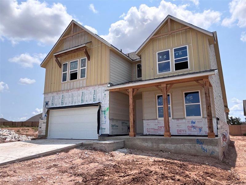 Front exterior of a new home in The Colony 50s, Bastrop, TX, highlighting curb appeal (Image 2). Front exterior of a new home in The Colony 50s, Bastrop, TX, highlighting curb appeal (Image 2).