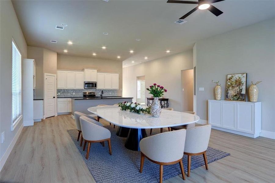 Dining area with light wood-type flooring, recessed lighting, and ceiling fan Dining area with light wood-type flooring, recessed lighting, and ceiling fan