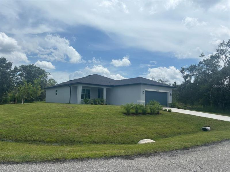 Front exterior of a new home in , North Port, FL, highlighting curb appeal (Image 17). Front exterior of a new home in , North Port, FL, highlighting curb appeal (Image 17).