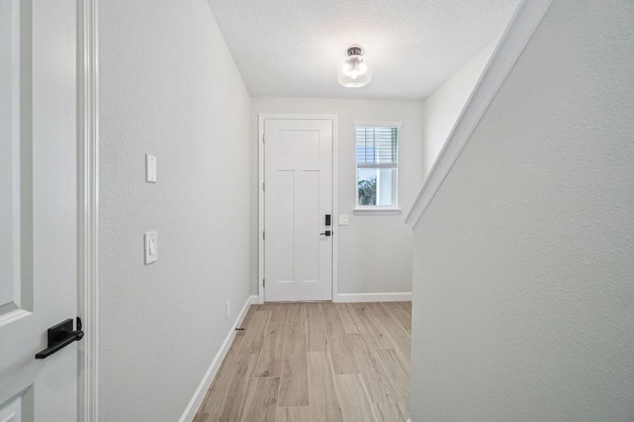 Staircase to second floor is located at the front of the home