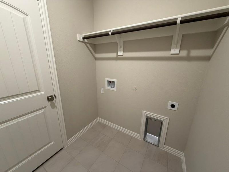 Utility area with tile flooring