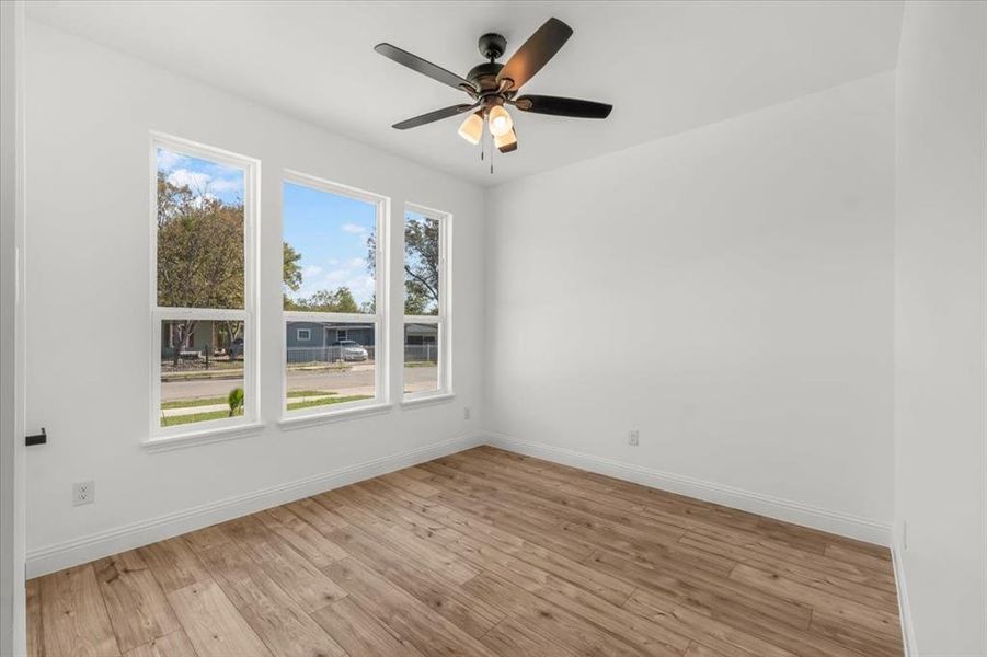 Spare room with light wood-type flooring and a ceiling fan