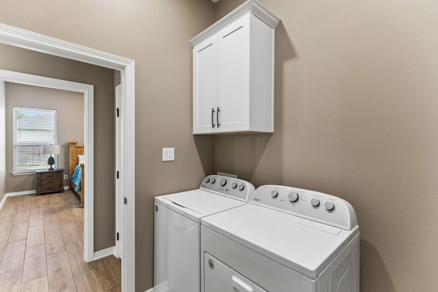 Thoughtfully positioned near the primary suite, the laundry room blends everyday convenience with additional storage.