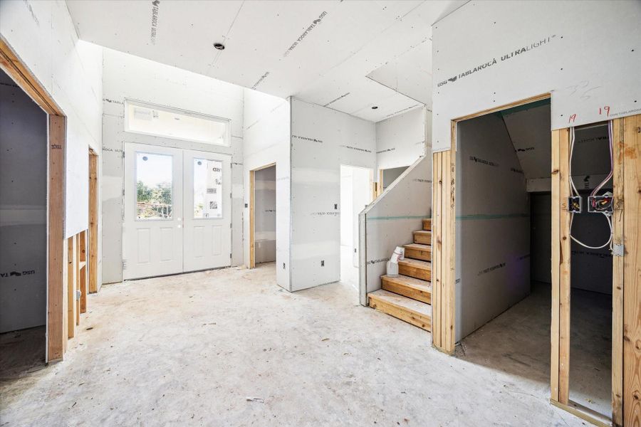 To the Left a private room with Double Doors that would make a great Study Nook or Wine Cellar! Under the Stairs storage to the left of the Staircase. In the Front Right of the Entry is a Study with a Half Bath