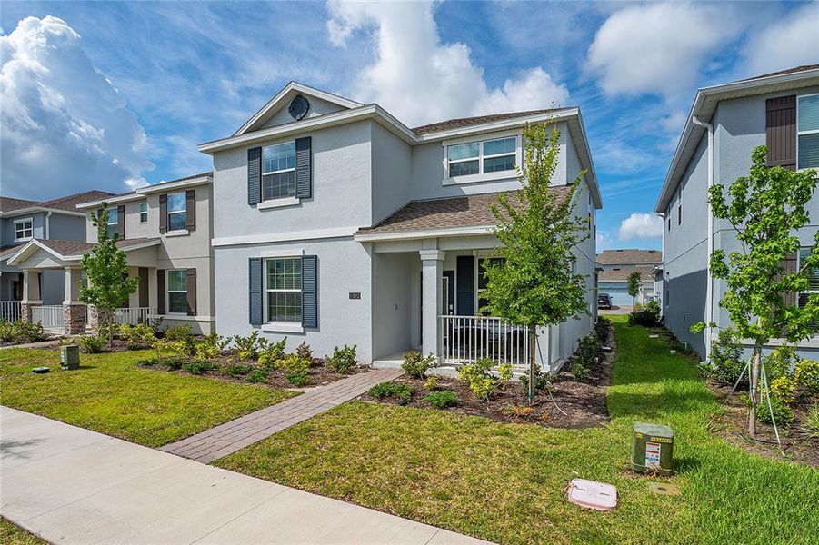 Front exterior of a new home in Storey Park: Innovation Manor Collection, Orlando, FL, highlighting curb appeal (Image 2).