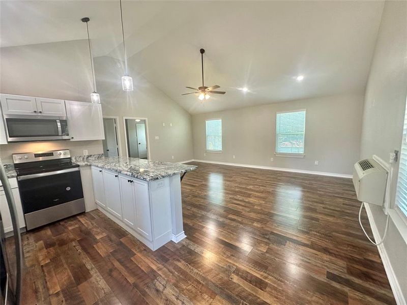 Upstairs Kitchen with appliances with stainless steel finishes, a peninsula, a ceiling fan, LVP flooring, and high vaulted ceiling Upstairs Kitchen with appliances with stainless steel finishes, a peninsula, a ceiling fan, LVP flooring, and high vaulted ceiling