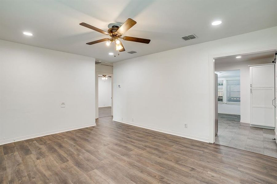 Living room with recessed lighting, wood finished floors, and a ceiling fan