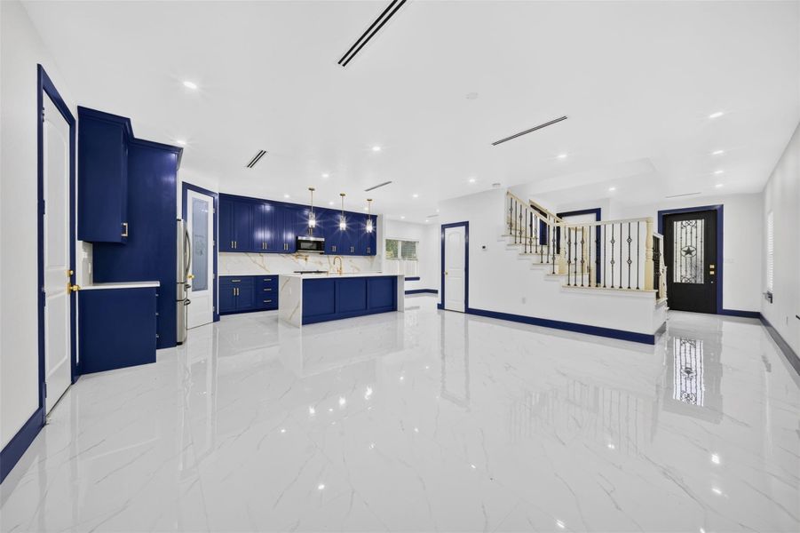Additional kitchen view showcasing generous cabinetry, counter space and open concept design