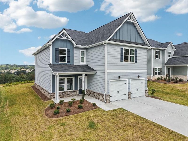 Front exterior of a new home in The Hills at Cedar Creek, Winder, GA, highlighting curb appeal (Image 2).