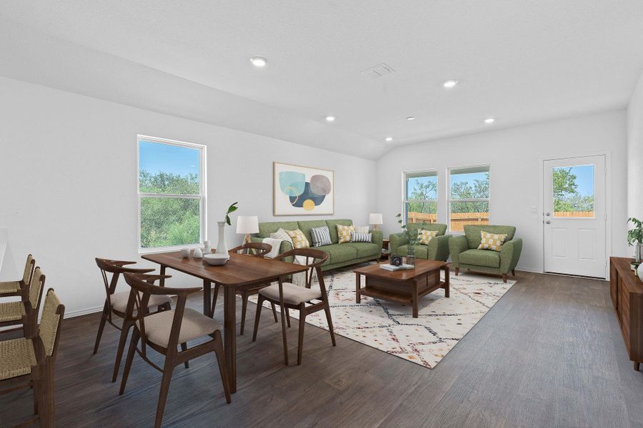 Living area with dark wood-style flooring, vaulted ceiling, and recessed lighting Living area with dark wood-style flooring, vaulted ceiling, and recessed lighting