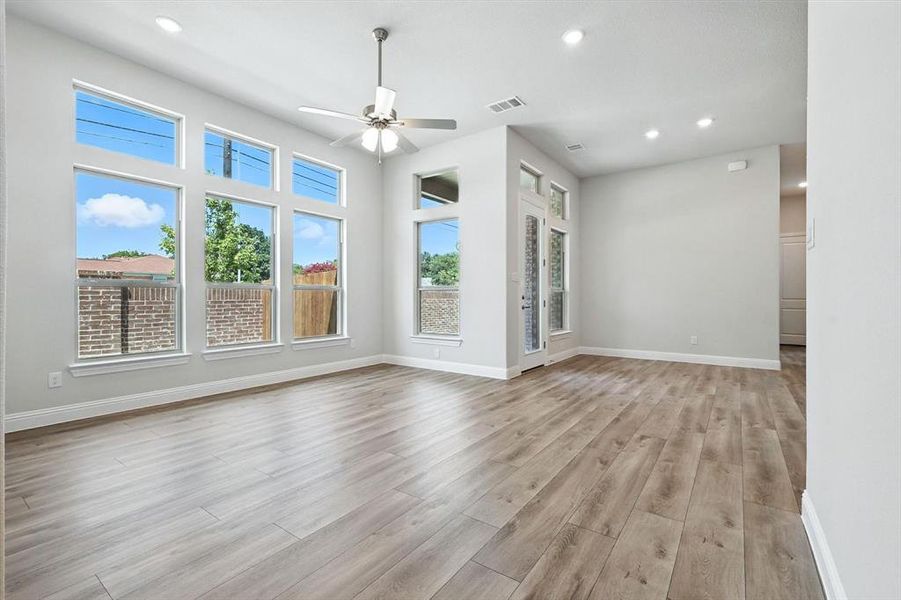 Unfurnished living room with recessed lighting, ceiling fan, and light wood finished floors Unfurnished living room with recessed lighting, ceiling fan, and light wood finished floors