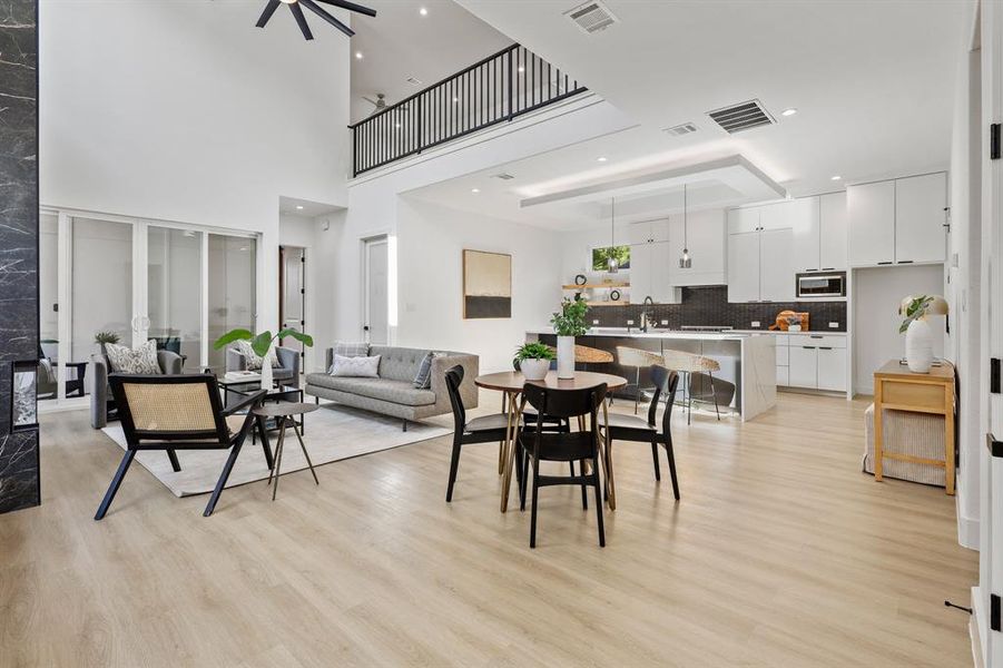 Dining room with light wood-type flooring, sink, and ceiling fan