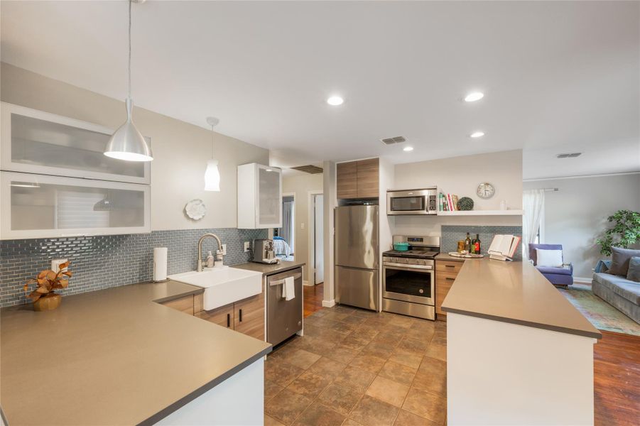 Culinary delights await in this modern kitchen with extensive counter space and sleek stainless appliances. Culinary delights await in this modern kitchen with extensive counter space and sleek stainless appliances.