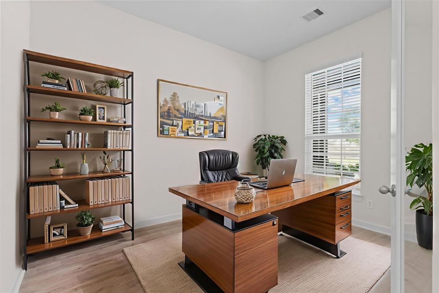 Virtually staged home office highlighting how the space can be transformed into a sophisticated and functional work-from-home environment with room for bookshelves, desk, and décor.