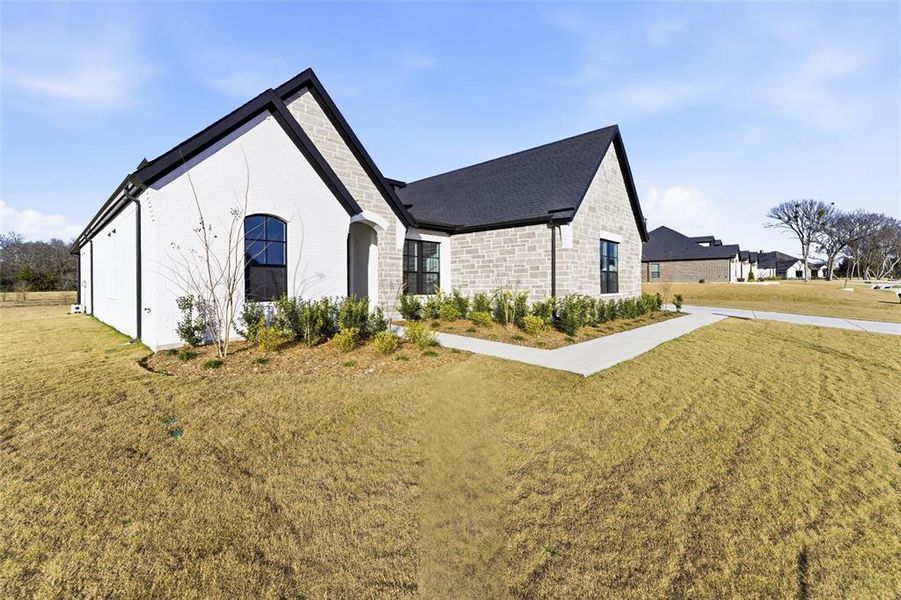 Front exterior of a new home in King Crossing Estates, Van Alstyne, TX, highlighting curb appeal (Image 23).