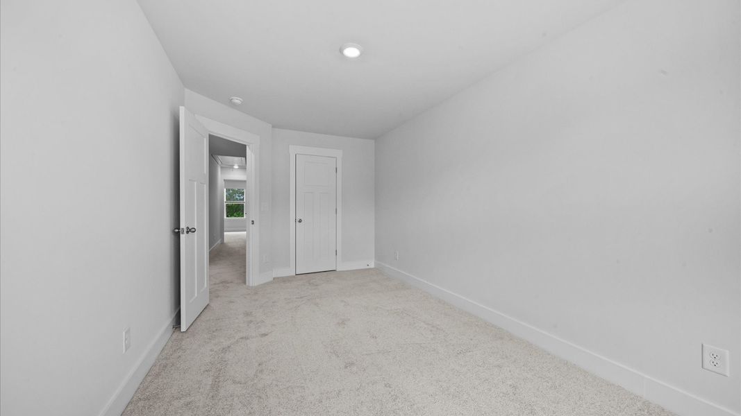 Bedroom with walk-in closet in two story townhome at Ransdell Pointe by DRB Homes in Spartanburg, SC