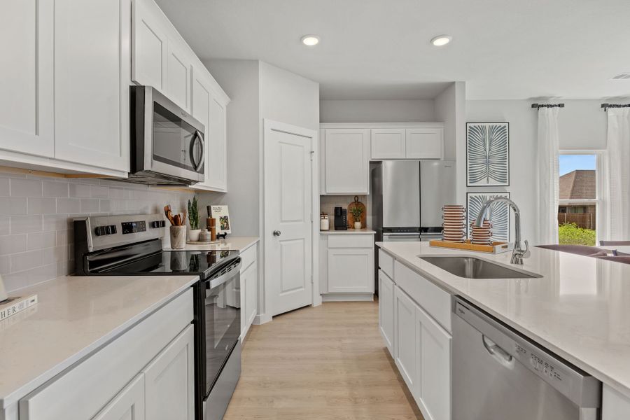 A kitchen with white cabinets. A kitchen with white cabinets.