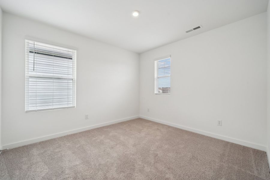 A room with a carpet and a carpet.