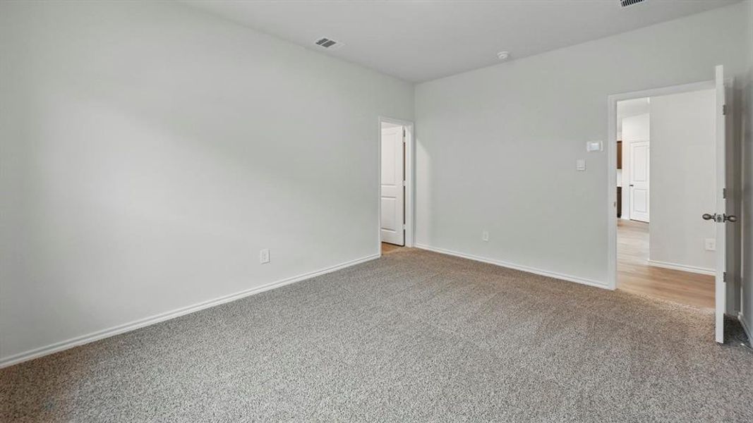 Empty room with carpet flooring and baseboards