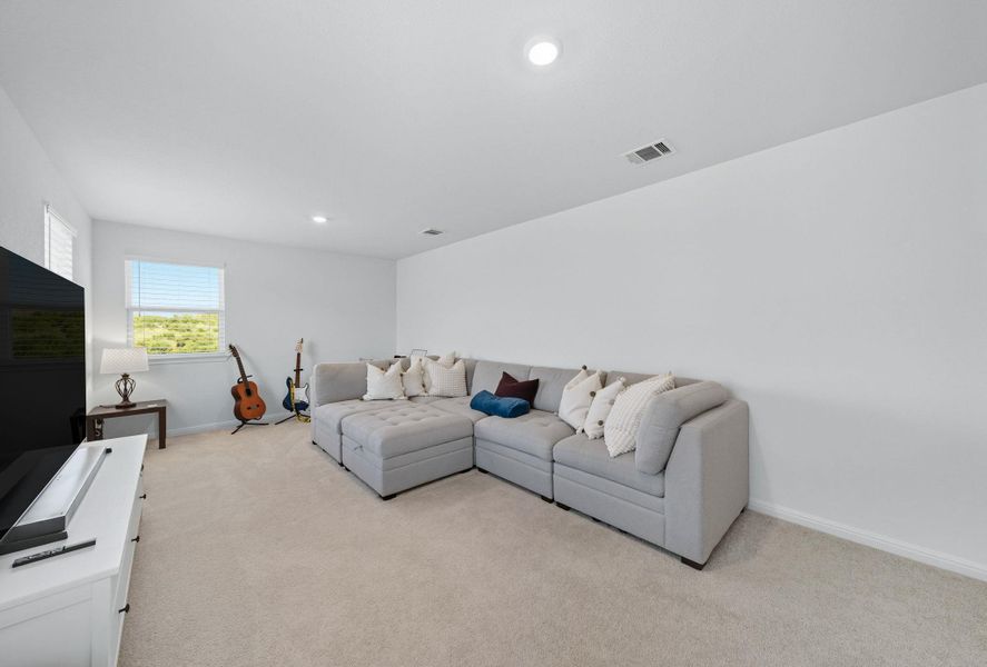 Living area with light colored carpet and recessed lighting Living area with light colored carpet and recessed lighting