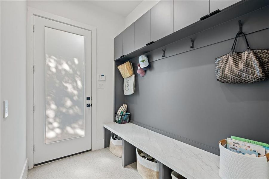 Mudroom with dark aggregate flooring