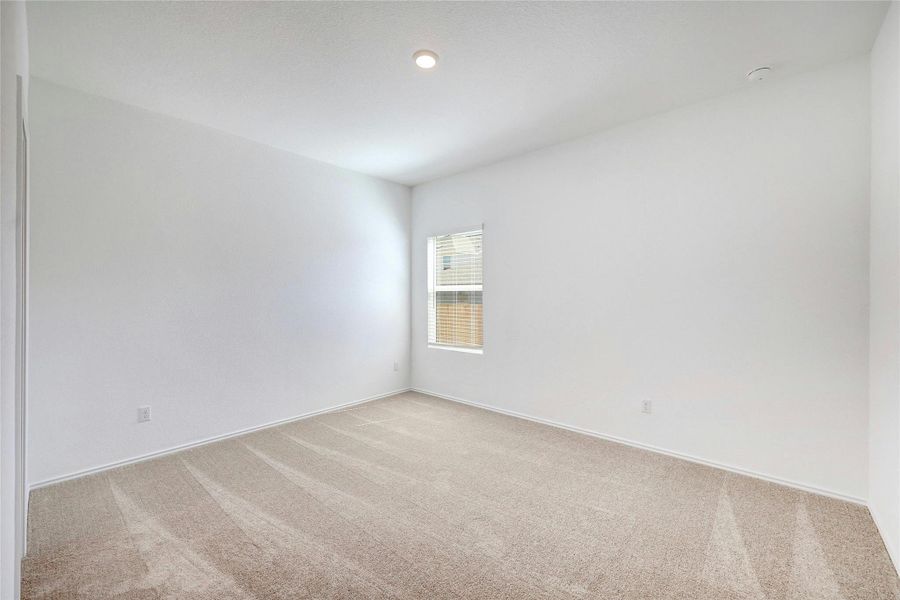 Spare room featuring light colored carpet