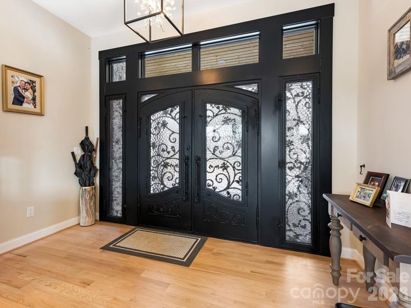 Solid iron doors into the home with transoms and side lights.