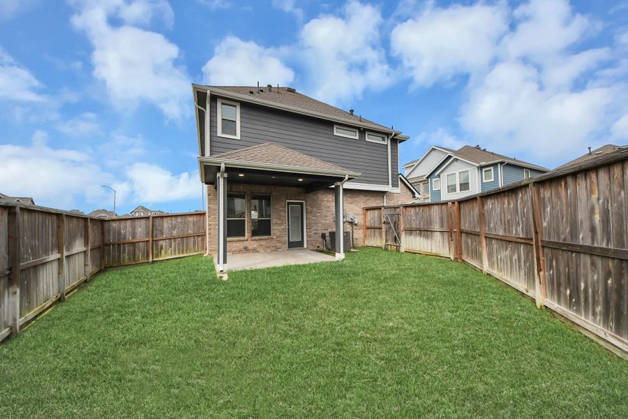 Exterior details and patio area of a home in The Groves, Humble (Image 4).