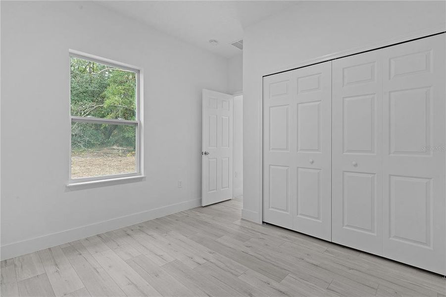 Bedroom 4 with window looking into back yard