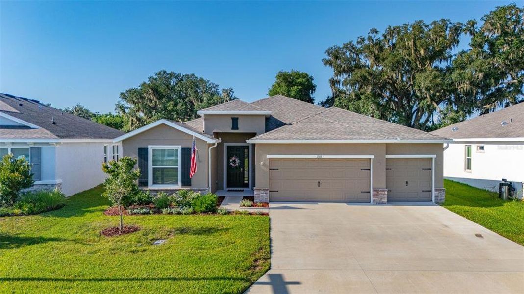 Front exterior of a new home in Farm at Varrea, Plant City, FL, highlighting curb appeal (Image 24). Front exterior of a new home in Farm at Varrea, Plant City, FL, highlighting curb appeal (Image 24).