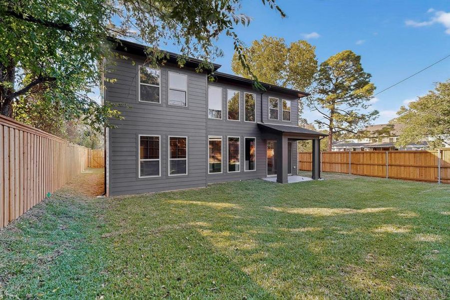 Rear view of property featuring a patio and a fenced backyard