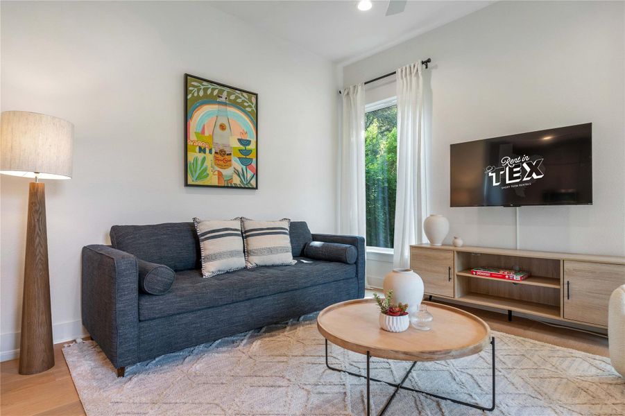 High ceilings and warm wood floors enhance this comfortable living space.