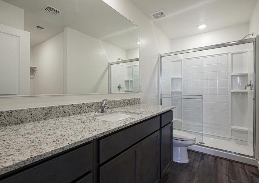 The master bath has a spacious, glass-enclosed shower.