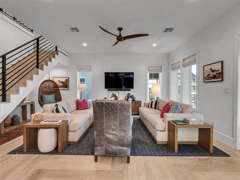 This inviting living area is where comfort meets coastal charm. Bathed in natural light pouring through generous windows, the space feels bright, airy, and full of life. The open layout and ample seating make it perfect for entertaining guests or enjoying slow mornings with coffee and ocean breezes drifting in. With its ceiling fan, soft tones, and relaxed elegance, this is the kind of living room that makes every gathering feel effortless — a true heart of the home where memories are made. This inviting living area is where comfort meets coastal charm. Bathed in natural light pouring through generous windows, the space feels bright, airy, and full of life. The open layout and ample seating make it perfect for entertaining guests or enjoying slow mornings with coffee and ocean breezes drifting in. With its ceiling fan, soft tones, and relaxed elegance, this is the kind of living room that makes every gathering feel effortless — a true heart of the home where memories are made.