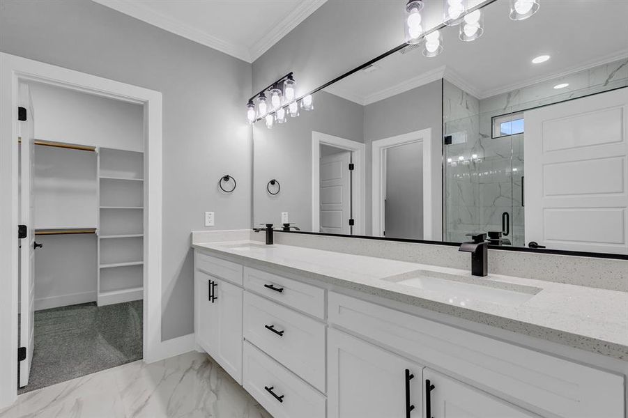 Bathroom featuring vanity, an enclosed shower, and ornamental molding