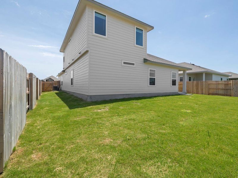 A generous backyard offers ample space for outdoor enjoyment and potential landscaping.