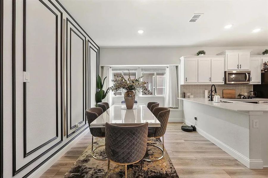 Dining space with sink and light hardwood / wood-style floors