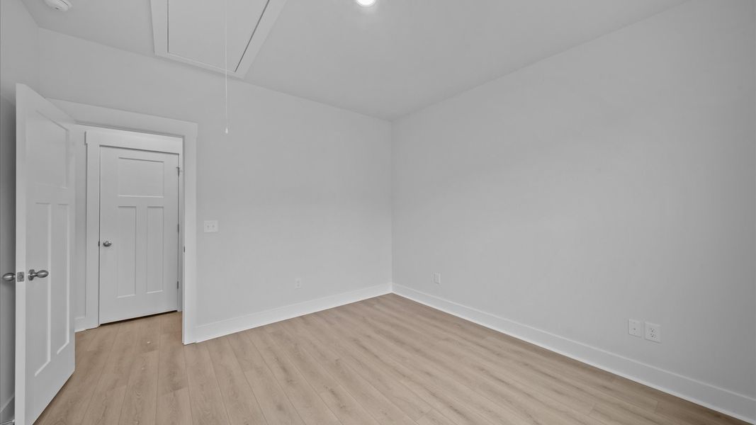 Elegant hardwood floors extend into spacious, light-filled secondary bedrooms Elegant hardwood floors extend into spacious, light-filled secondary bedrooms