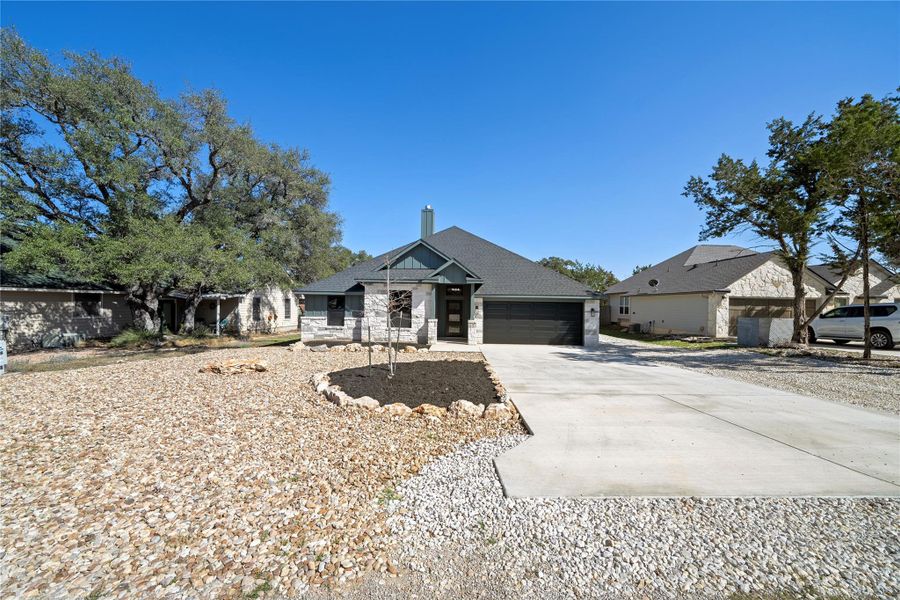 Front exterior of a new home in , Wimberley, TX, highlighting curb appeal (Image 23).