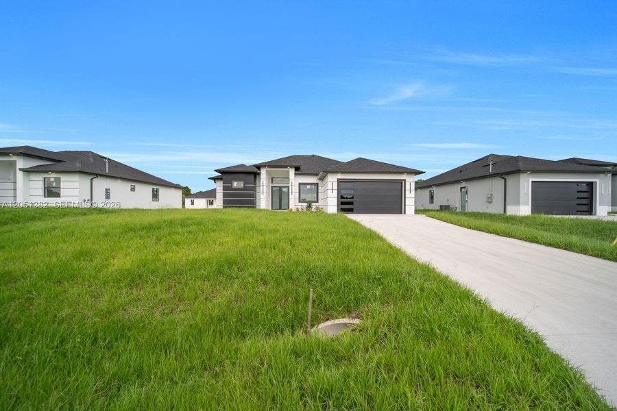 Front exterior of a new home in , Lehigh Acres, FL, highlighting curb appeal (Image 1). Front exterior of a new home in , Lehigh Acres, FL, highlighting curb appeal (Image 1).